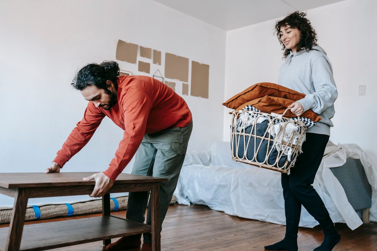 services-02 A couple organizing furniture and packing in a modern apartment for relocation.